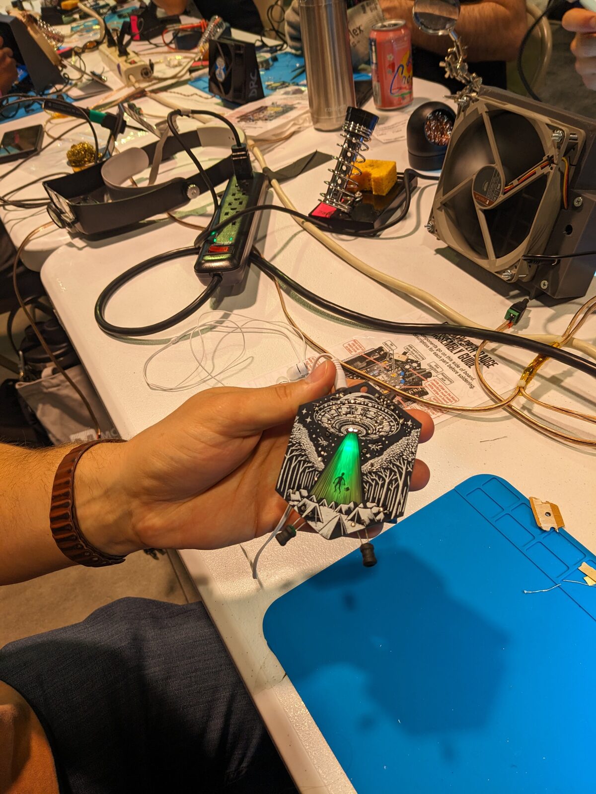 Participant holding a glowing completed EMF Explorer badge